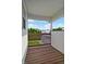 Balcony with wood flooring, a wood railing, and a view of the greenery and neighborhood at 4948 Potomac Square Pl, Indianapolis, IN 46268