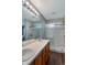 Bathroom with double sinks, spacious countertop, modern lighting, and a glass shower at 4948 Potomac Square Pl, Indianapolis, IN 46268