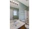 Bathroom with a tub-shower combo, single sink vanity, and a large mirror with modern lighting at 4948 Potomac Square Pl, Indianapolis, IN 46268
