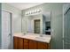 Bathroom showcasing a double sink vanity, a large mirror with modern lighting, and a closet at 4948 Potomac Square Pl, Indianapolis, IN 46268