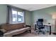 Bedroom featuring a daybed, desk with monitor and chair, and a large window for natural light at 4948 Potomac Square Pl, Indianapolis, IN 46268