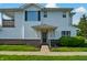 Attractive condo featuring brick accents, green shutters, and a well-kept lawn at 4948 Potomac Square Pl, Indianapolis, IN 46268