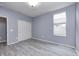 Inviting bedroom featuring a window, closet with sliding doors and wood-look flooring at 5110 Lilium Dr, Plainfield, IN 46168