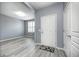 Bright foyer with gray walls, stylish flooring, and a view into the adjacent living space at 5110 Lilium Dr, Plainfield, IN 46168