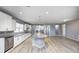Open kitchen featuring an island, stainless steel appliances, and modern white cabinetry at 5110 Lilium Dr, Plainfield, IN 46168