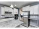 Stylish kitchen with stainless steel appliances, granite countertops, and white cabinets at 5110 Lilium Dr, Plainfield, IN 46168