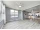 Bright living area with sleek flooring, expansive windows, and an open flow to the kitchen at 5110 Lilium Dr, Plainfield, IN 46168