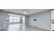 Open-concept living area with sleek flooring, large windows, and seamless flow to the adjacent spaces at 5110 Lilium Dr, Plainfield, IN 46168