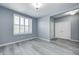 Inviting living room featuring sleek flooring, a large window with shutters, and neutral wall paint at 5110 Lilium Dr, Plainfield, IN 46168