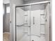 Modern shower with sleek sliding glass doors, grab bars, and easy-to-clean white surround at 5110 Lilium Dr, Plainfield, IN 46168