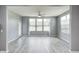 Bright sunroom with large windows, sleek flooring, and a ceiling fan for comfortable living at 5110 Lilium Dr, Plainfield, IN 46168