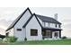 Elegant white brick house showcasing a stylish covered patio and manicured greenery enhancing curb appeal at 5488 Stonewood Ct, Bargersville, IN 46106