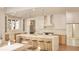 Modern kitchen featuring a large island with seating, white cabinets, and stainless steel appliances at 5488 Stonewood Ct, Bargersville, IN 46106