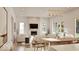 Bright, open-concept living room with stone fireplace, hardwood floors, and an abundance of natural light at 5488 Stonewood Ct, Bargersville, IN 46106