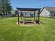 Spacious backyard featuring a pergola with a rustic picnic table setup at 5703 Wood Hollow Dr, Indianapolis, IN 46239