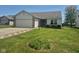 Charming single-story home with a well-manicured lawn and attached two-car garage at 5703 Wood Hollow Dr, Indianapolis, IN 46239