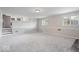 Finished basement with neutral carpet, paneled walls, and a kitchenette at 5719 Laurel Hall Dr, Indianapolis, IN 46226