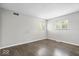 Bright bedroom with hardwood floors, neutral walls, and natural light at 5719 Laurel Hall Dr, Indianapolis, IN 46226
