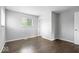A bright bedroom featuring a window and dark hardwood floors at 5719 Laurel Hall Dr, Indianapolis, IN 46226