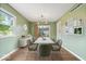 Dining room with light green walls, hardwood floors, and a sliding glass door at 5719 Laurel Hall Dr, Indianapolis, IN 46226