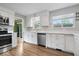 Modern kitchen with stainless steel appliances, white cabinets, quartz countertops, and ample storage space at 5719 Laurel Hall Dr, Indianapolis, IN 46226