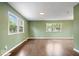 Spacious room with natural light, wood flooring and three large windows at 5719 Laurel Hall Dr, Indianapolis, IN 46226