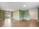 Open living room with hardwood floors, neutral walls, and sliding glass doors to the backyard at 5719 Laurel Hall Dr, Indianapolis, IN 46226