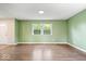 Inviting living room featuring hardwood floors, a large window, and neutral green walls at 5719 Laurel Hall Dr, Indianapolis, IN 46226