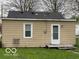 This home includes a functional back door and access to the yard, with simple exterior features at 598 Young St, Franklin, IN 46131