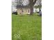 View of the expansive yard with a charming vintage windmill, offering lots of outdoor space at 598 Young St, Franklin, IN 46131