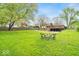 Expansive backyard with lush green grass and mature trees, ideal for outdoor activities and relaxation at 6340 Monitor Ln, Indianapolis, IN 46220