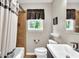 Clean bathroom featuring modern sink, window, toilet, and shower tub combination at 6340 Monitor Ln, Indianapolis, IN 46220