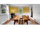 Bright dining room with white brick accents, large windows, and a wooden dining table at 6340 Monitor Ln, Indianapolis, IN 46220