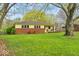 Charming ranch home with a brick accent, covered porch and beautiful, mature trees at 6340 Monitor Ln, Indianapolis, IN 46220