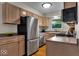 Well-lit kitchen with stainless steel appliances and wooden cabinets, offering a modern cooking space at 6340 Monitor Ln, Indianapolis, IN 46220