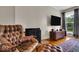 Bright living room features hardwood floors, decorative fireplace, and TV at 6340 Monitor Ln, Indianapolis, IN 46220