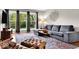 Cozy living room featuring a gray sectional, a leather chair, and a large window at 6340 Monitor Ln, Indianapolis, IN 46220