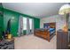 The bedroom has bright green walls, a large bed, and neutral-tone carpet at 6373 Thornridge Dr, Avon, IN 46123