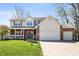 Inviting two-story home with brick and vinyl siding, featuring a well-maintained lawn and an attached garage at 6373 Thornridge Dr, Avon, IN 46123