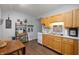 Well-equipped kitchen with wood cabinets, modern appliances, and a cozy dining area at 6373 Thornridge Dr, Avon, IN 46123
