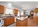 Functional kitchen with oak cabinetry, ample countertop space, and modern appliances for convenient meal preparation at 6373 Thornridge Dr, Avon, IN 46123