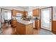Well-lit kitchen features an island, wood cabinets, and easy access to a breakfast area with backyard views at 6373 Thornridge Dr, Avon, IN 46123