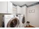 Modern white appliances line the walls of this bright laundry room at 6373 Thornridge Dr, Avon, IN 46123