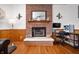 Cozy living room featuring a brick fireplace, wood floors, and comfortable seating at 6373 Thornridge Dr, Avon, IN 46123