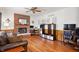 Relaxing living room featuring a brick fireplace, hardwood floors, and stylish decor for a comfortable atmosphere at 6373 Thornridge Dr, Avon, IN 46123