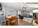 Open-concept living area with dining space, wood floors, and cozy sectional sofa at 6373 Thornridge Dr, Avon, IN 46123