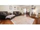 Spacious living room with hardwood floors, a cozy seating area, and natural light from an open layout at 6373 Thornridge Dr, Avon, IN 46123