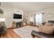 Bright living room boasts hardwood floors, modern decor, and a seamless connection to the entryway and staircase at 6373 Thornridge Dr, Avon, IN 46123