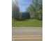 Two-story brick home featuring a small balcony, a large front lawn, and surrounded by trees at , Indianapolis, IN 46221