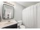 Simple bathroom features modern lighting, a white shower curtain, and vinyl flooring at 6459 Titania Dr, Indianapolis, IN 46236